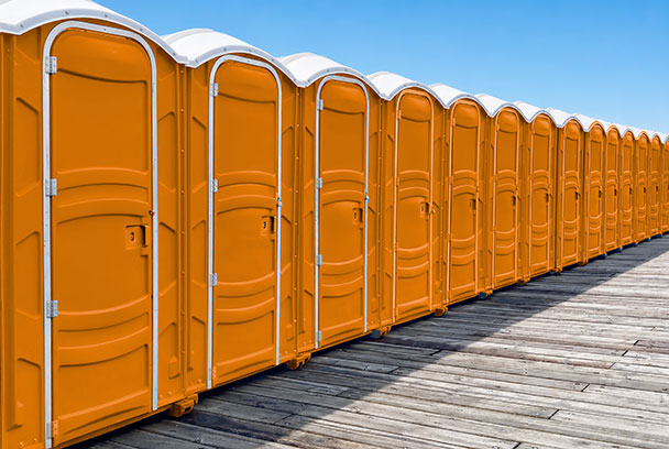 row of orange portable restrooms